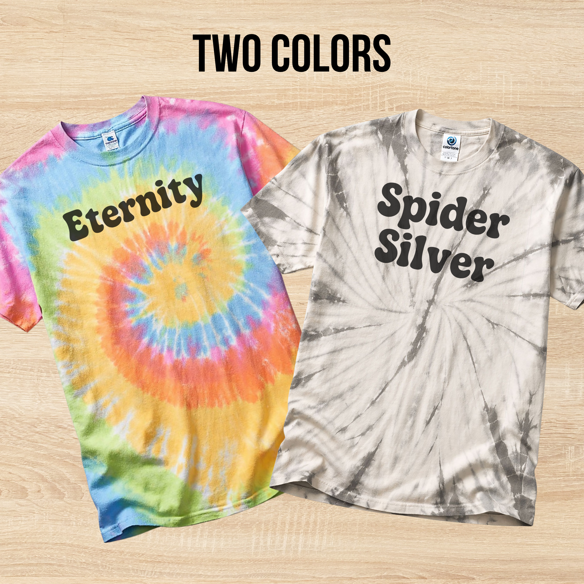 Two tie-dye t-shirts with 'Eternity' and 'Spider Silver' text on a wooden surface.