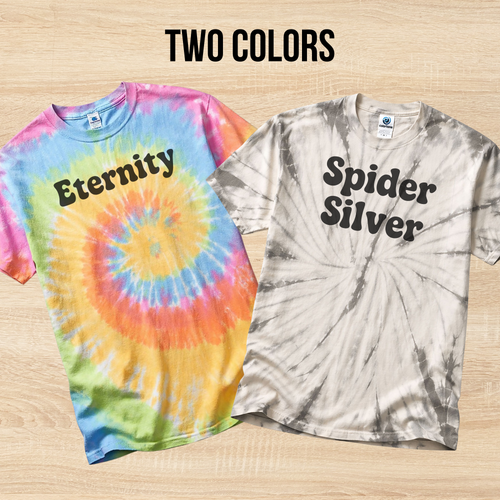 Two tie-dye t-shirts with 'Eternity' and 'Spider Silver' text on a wooden surface.