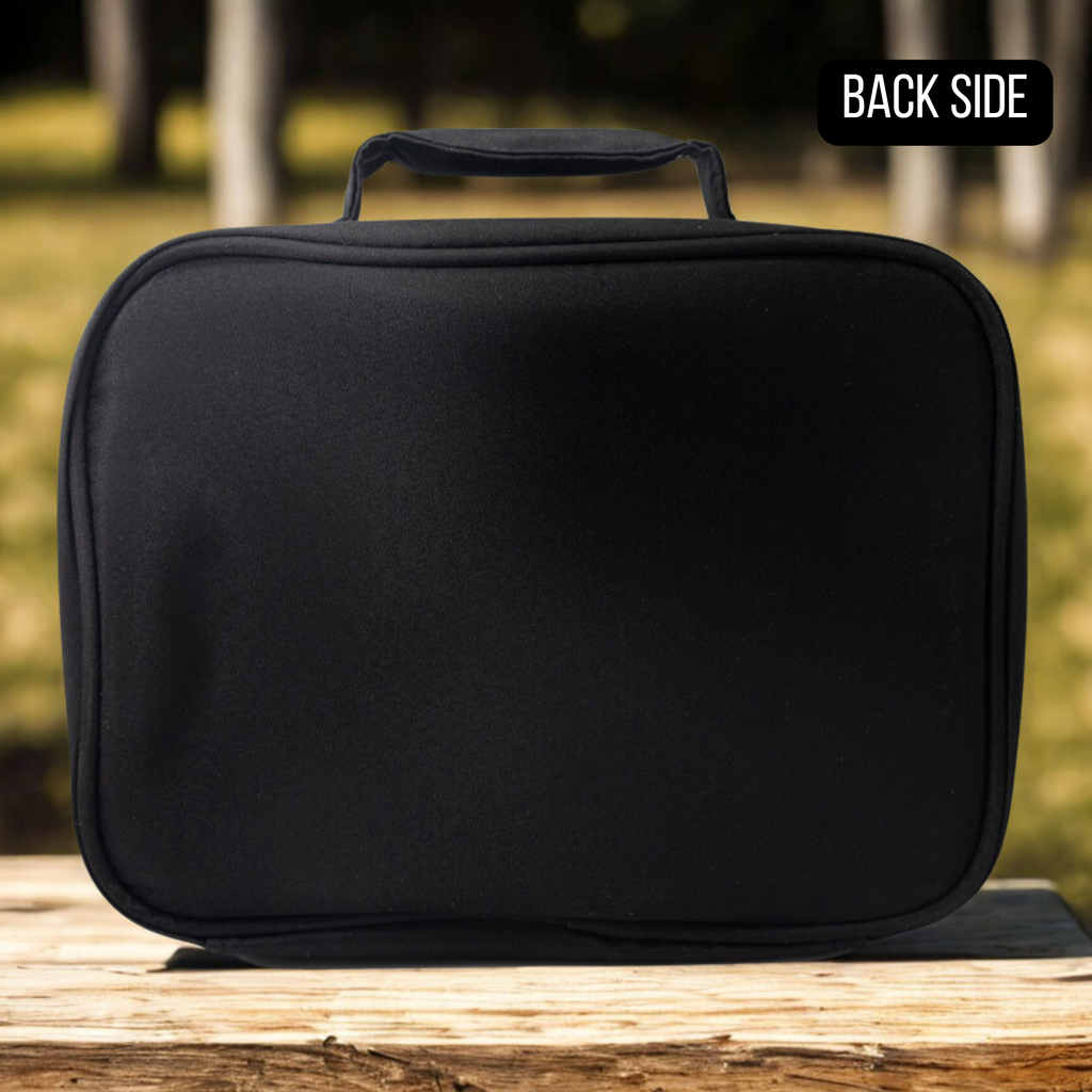 Back side of Black insulated lunch bag on a wooden surface with a blurred natural background