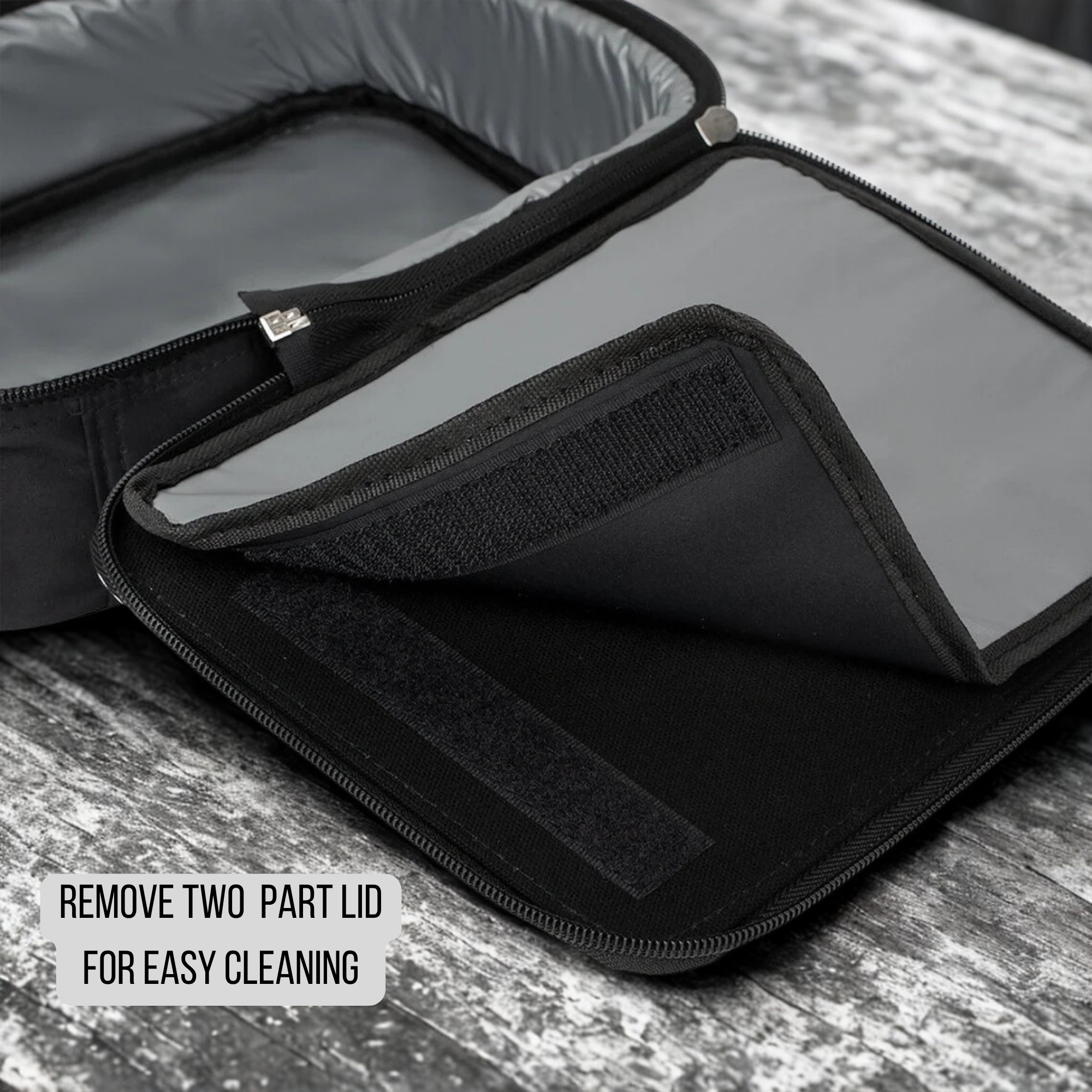 Black insulated lunch bag with two-part lid on a wooden surface