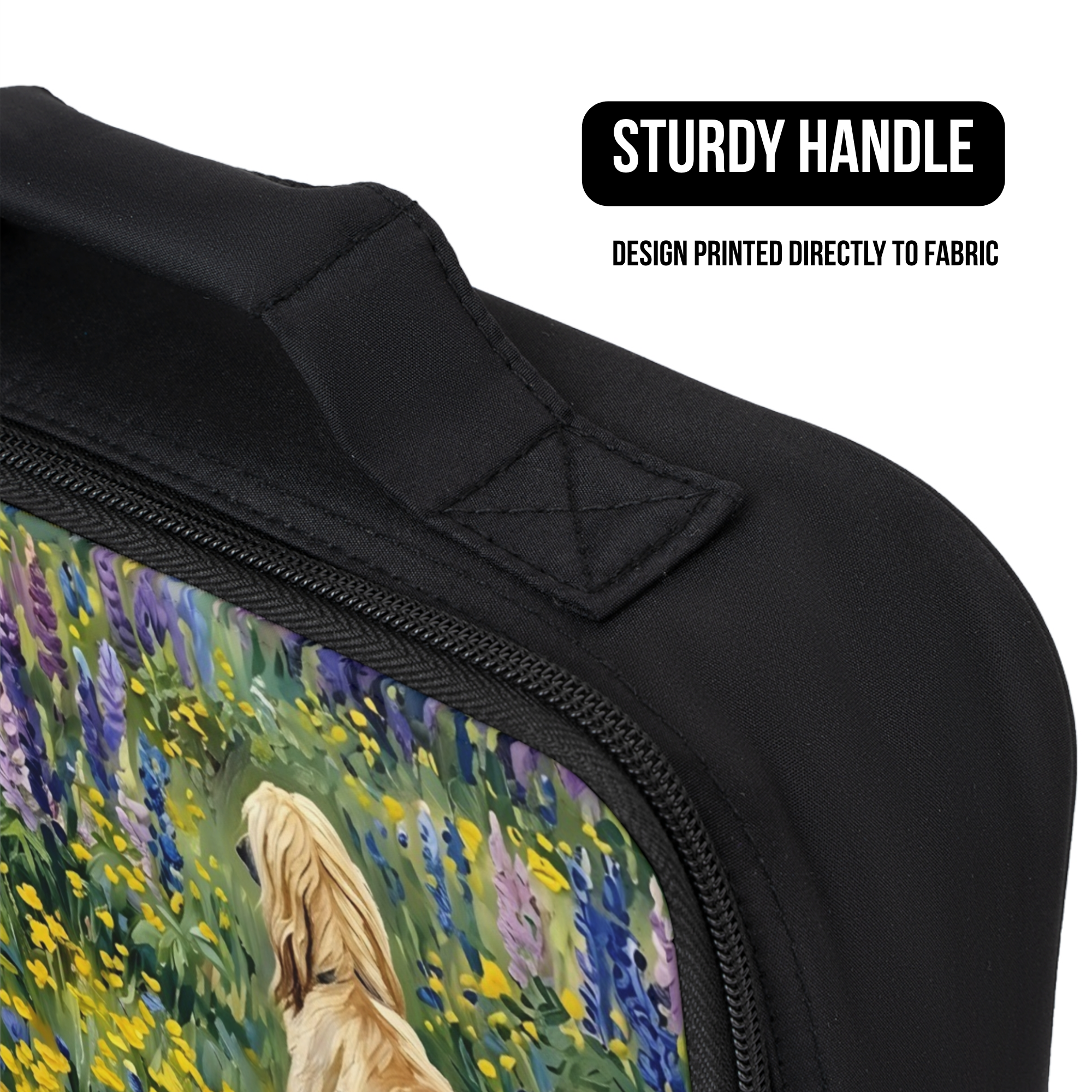 Close up of a black lunch bag with a design of a dog in a field of flowers, featuring a sturdy handle, and direct to fabric printing.