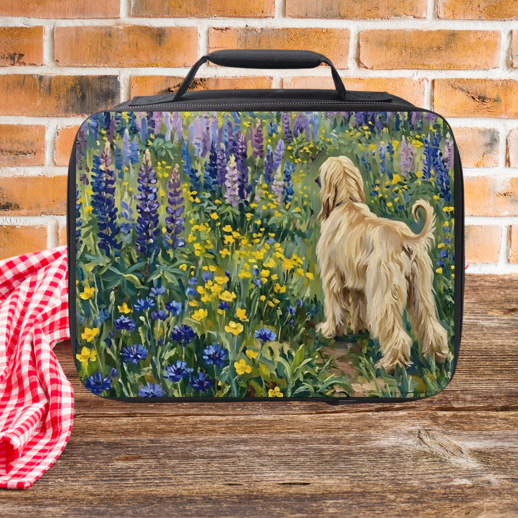 Insulated lunch bag with a floral Afghan hound dog design on a wooden picnic table and a brick wall background.