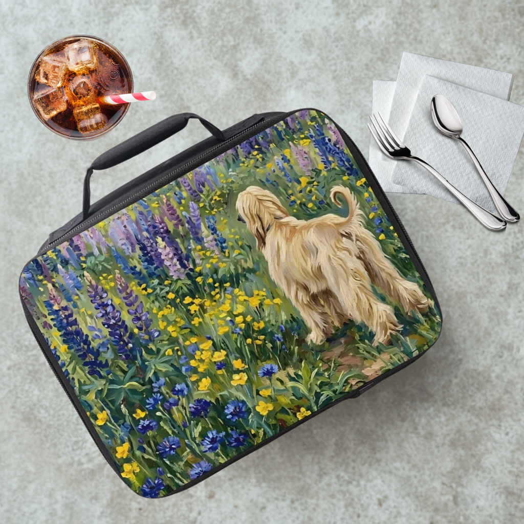 Lunch bag with a dog and flowers design on a table with a drink and utensils.