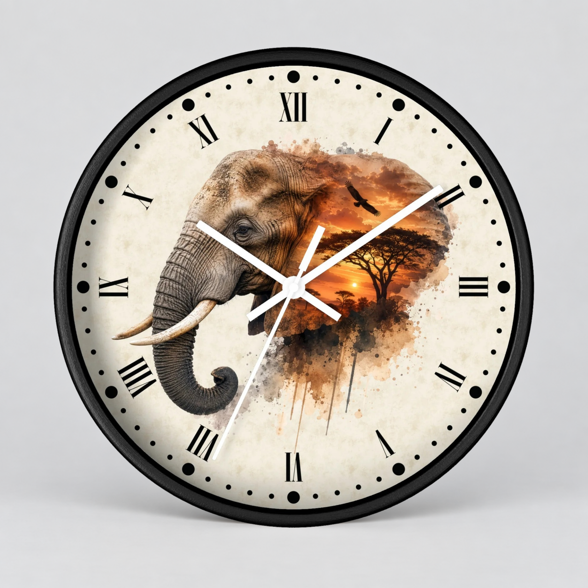 A round wall clock with a black frame and Roman numerals, featuring a watercolor-style illustration of an elephant and a savanna sunset on the clock face, shown against a light gray background.