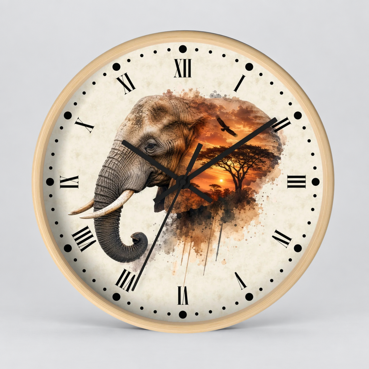 Round wall clock with a light wood frame and a cream-colored face featuring a large elephant illustration over an African savanna sunset scene with black Roman numerals and clock hands.