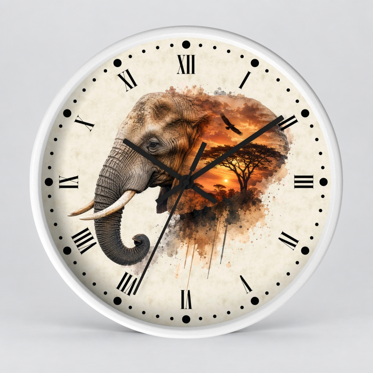 A round wall clock with a white frame and a cream-colored face featuring a watercolor-style elephant and African savanna scene in warm brown, orange, and black tones. Black Roman numerals and clock hands are visible on the front.