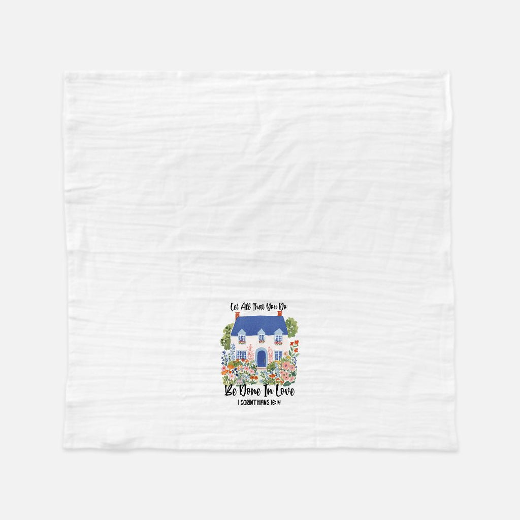 White tea towel with a colorful house design and quoted scripture text on a white background