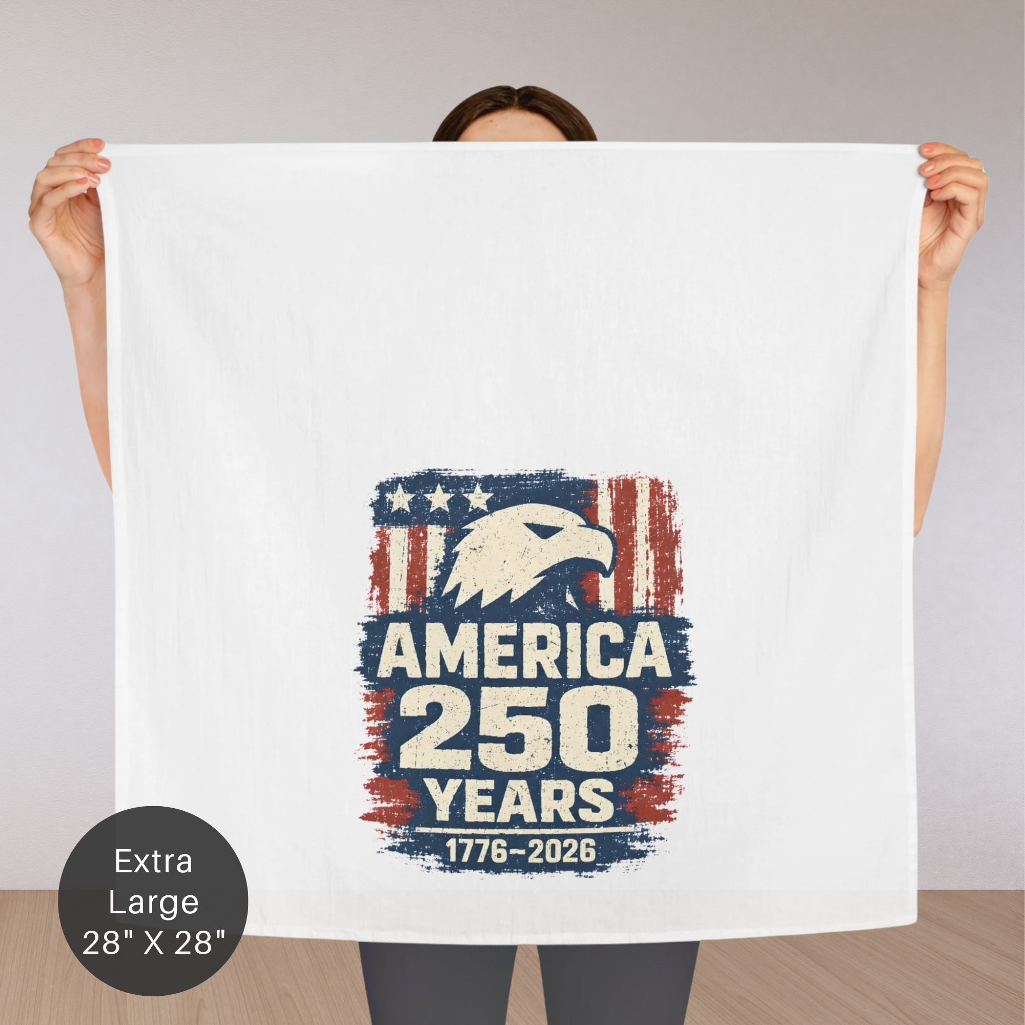 Person holding an extra large tea towel with 'America 250 Years' design featuring an eagle.
