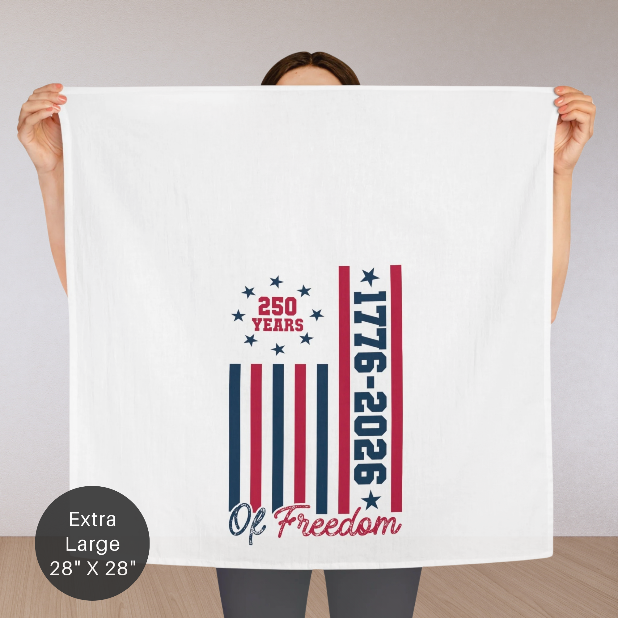Person holding an extra large tea towel with '250 Years 1776-2026 Of Freedom' design.