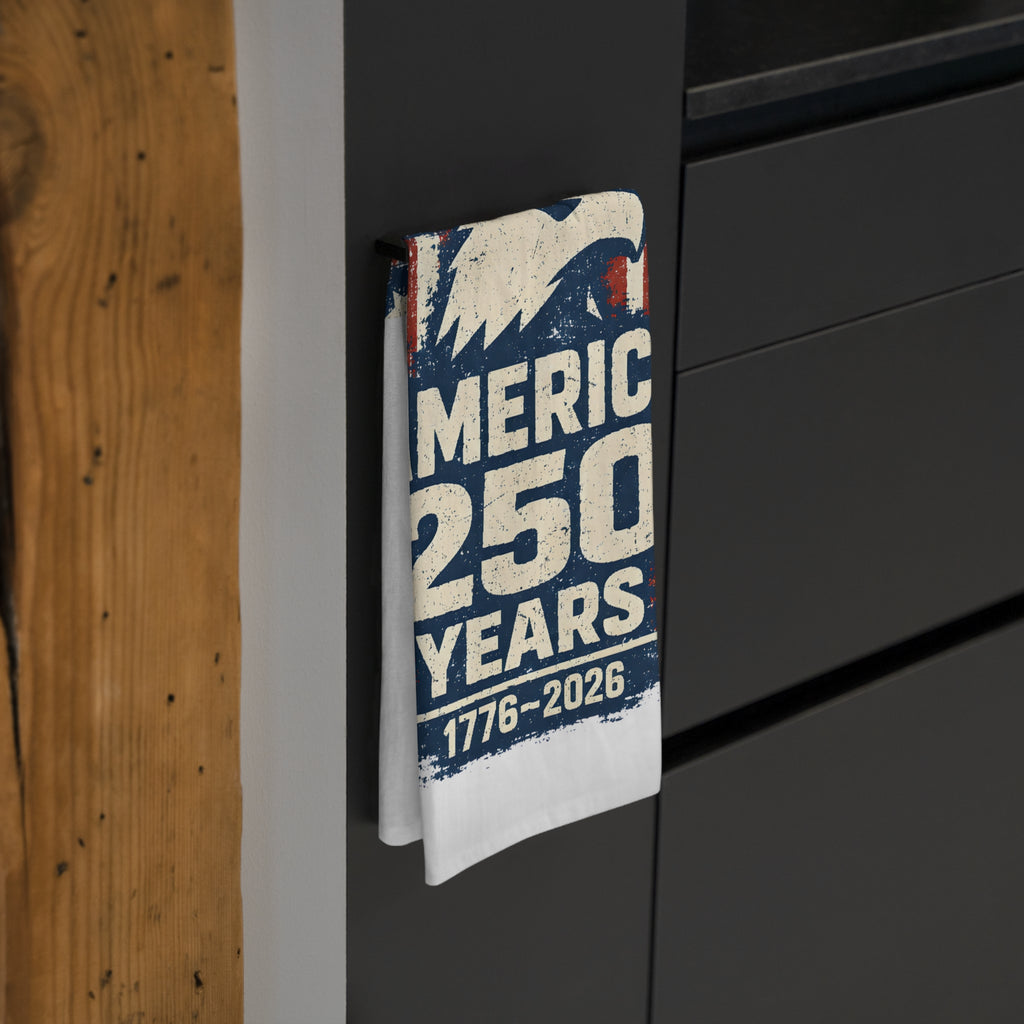 Tea towel celebrating 250 years of 'America' on a surface with wooden and black background.