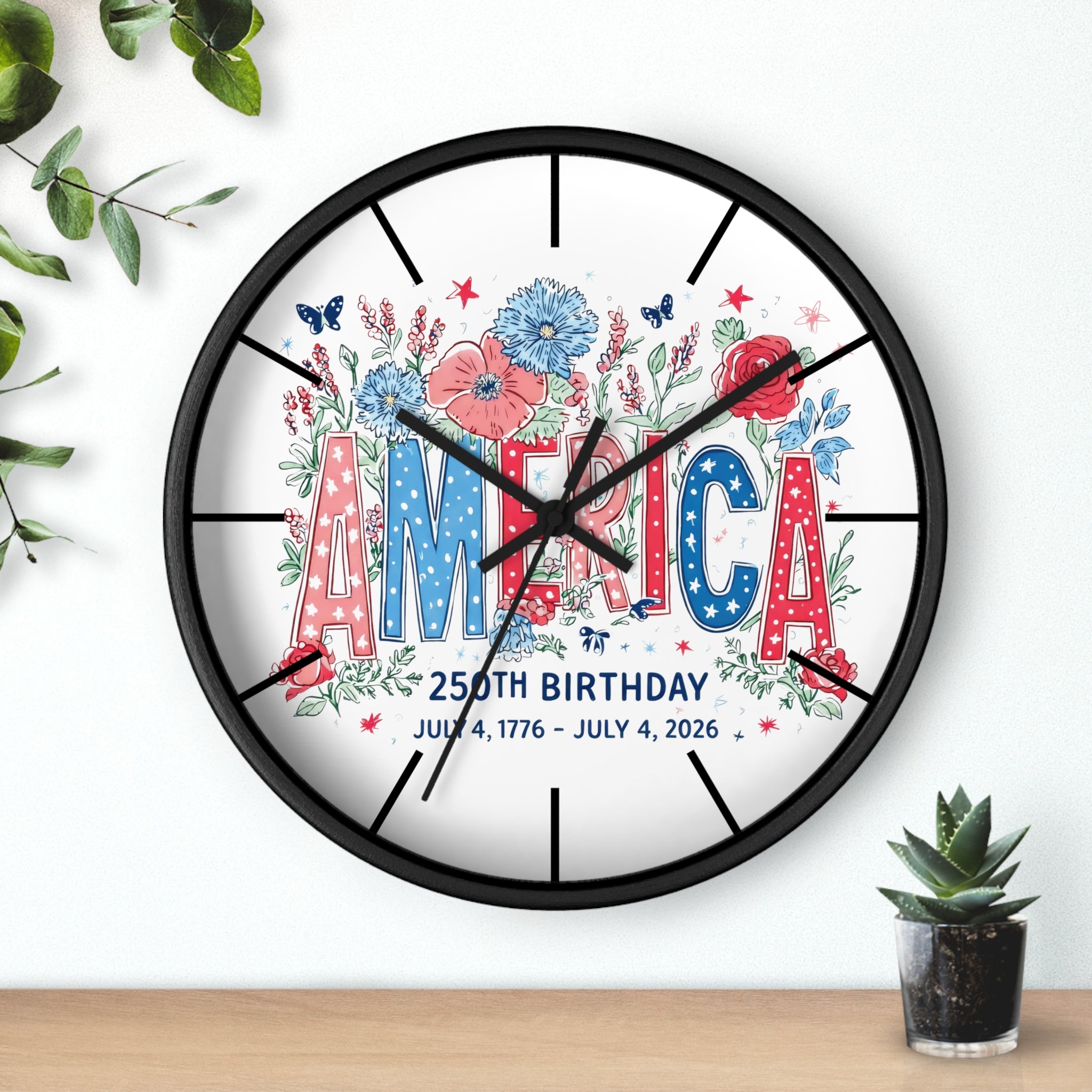 Round black decorative wall clock with 'America' and floral design on a white background