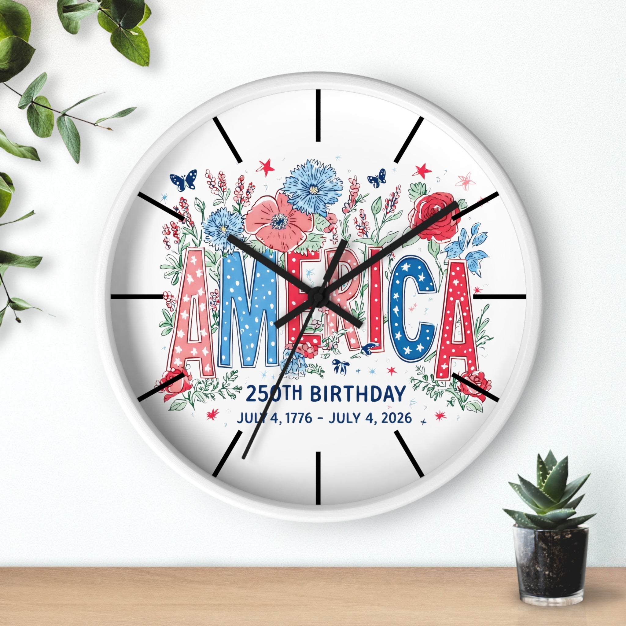 Decorative wall clock with 'America' and floral design on a white background