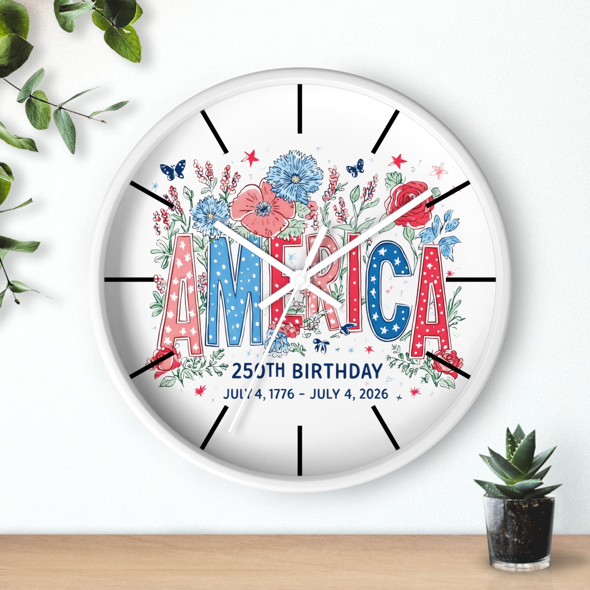 White Decorative wall clock with 'AMERICA' and floral design on a white background