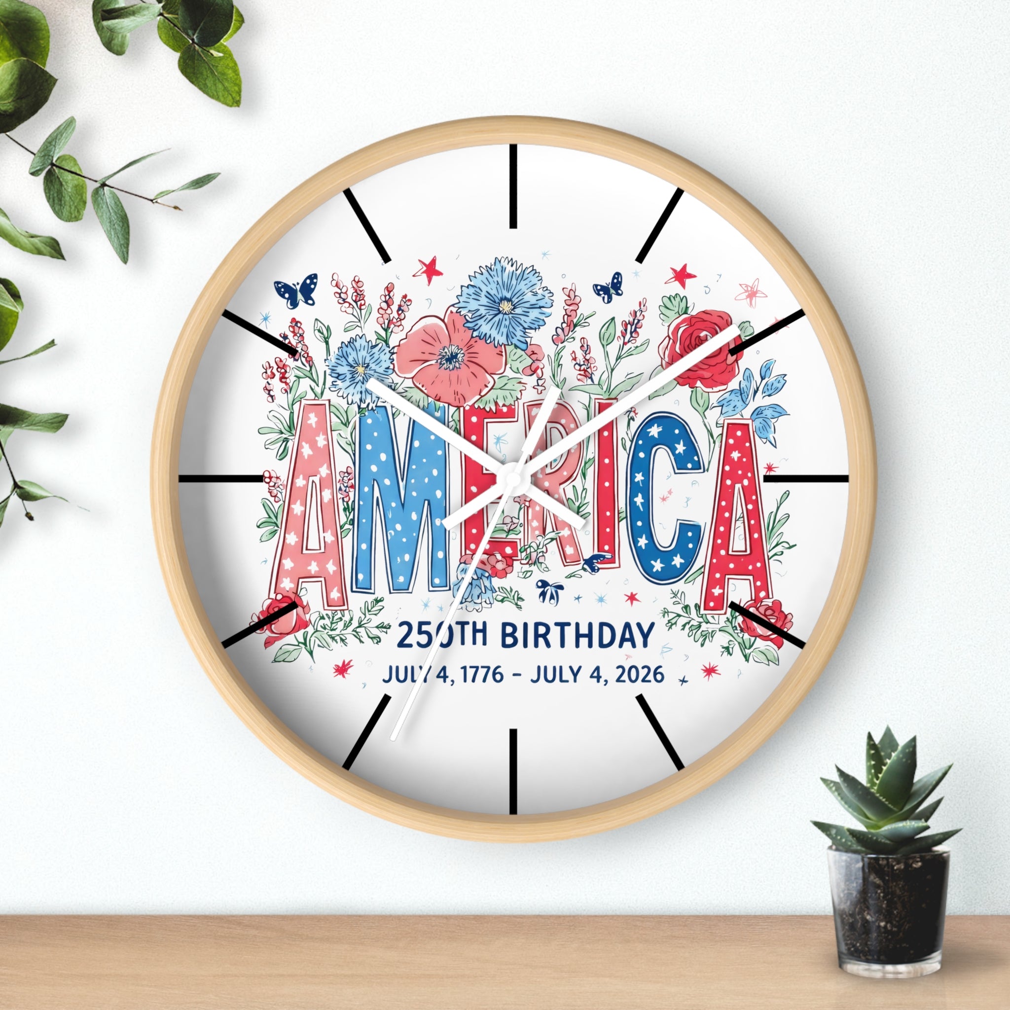 Decorative round wood wall clock with 'AMERICA' and floral design on a white background
