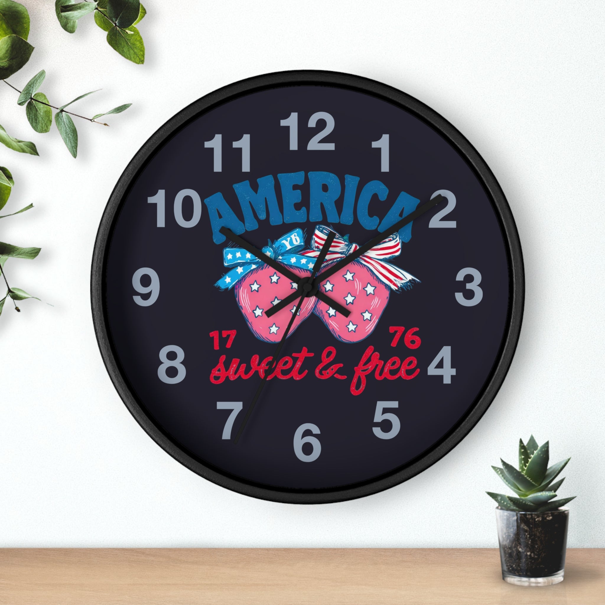 Round Black Wall clock with decorative strawberry fourth of July design and text on a white background