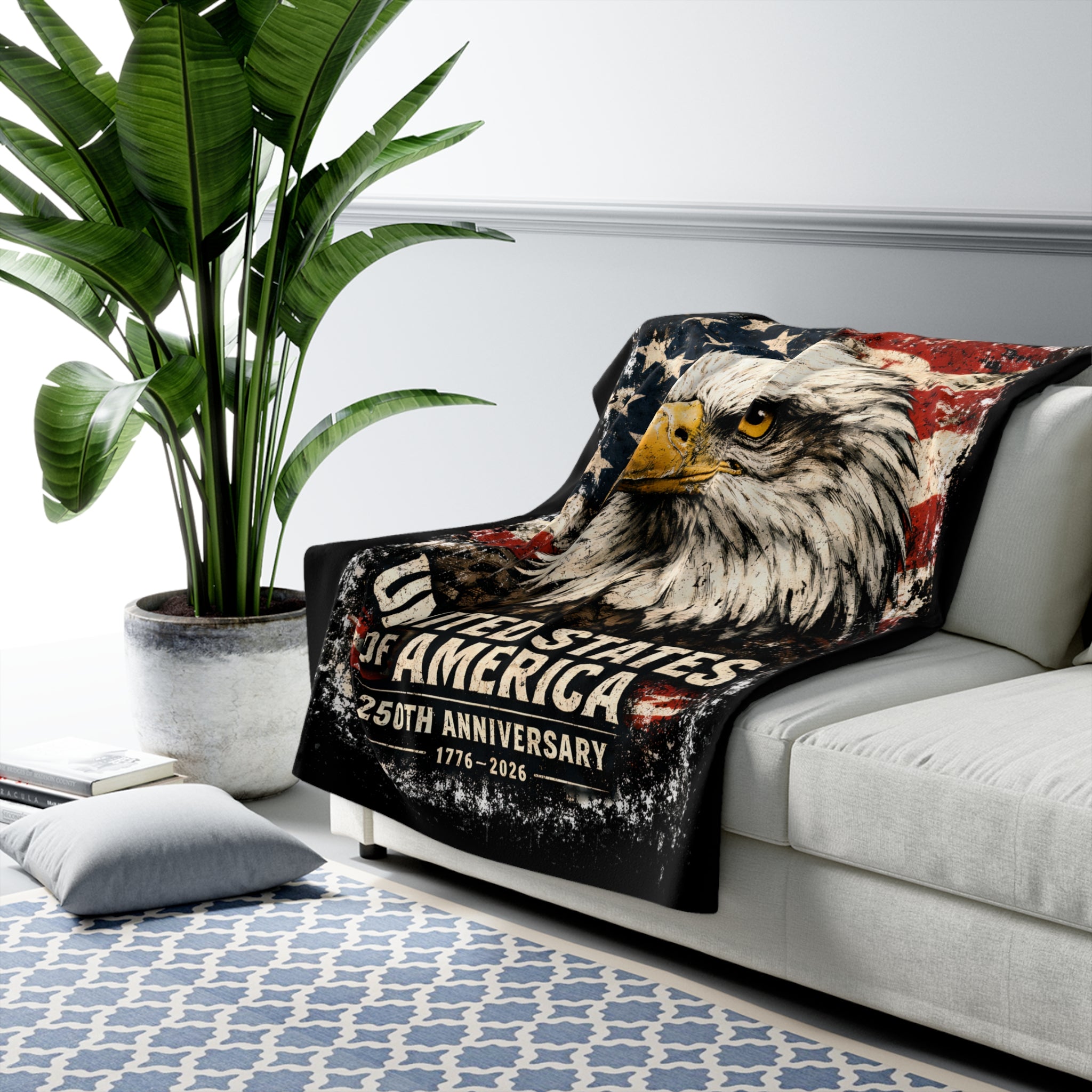 Blanket with an eagle design featuring 'United States of America 250th Anniversary' on a couch in a living room.