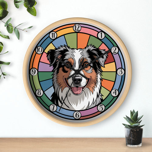 Wall clock with a Australian Shepherd dog illustration on a colorful background, placed on a wooden surface with a plant.