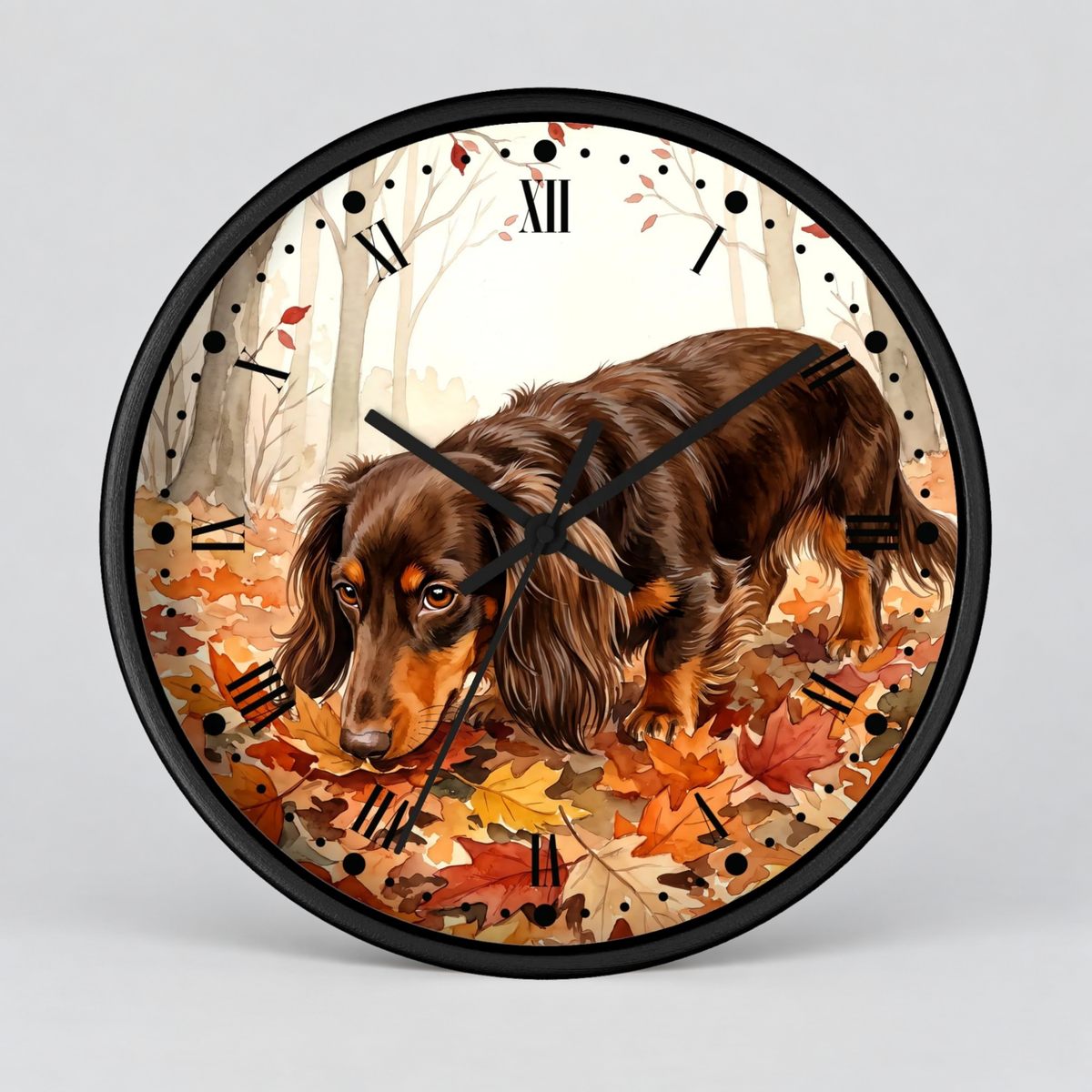 Round wall clock with a black frame and a printed illustration of a long-haired brown dachshund walking through orange and red autumn leaves in a light-colored forest. The clock face has black Roman numerals and black hands, shown against a light gray background.