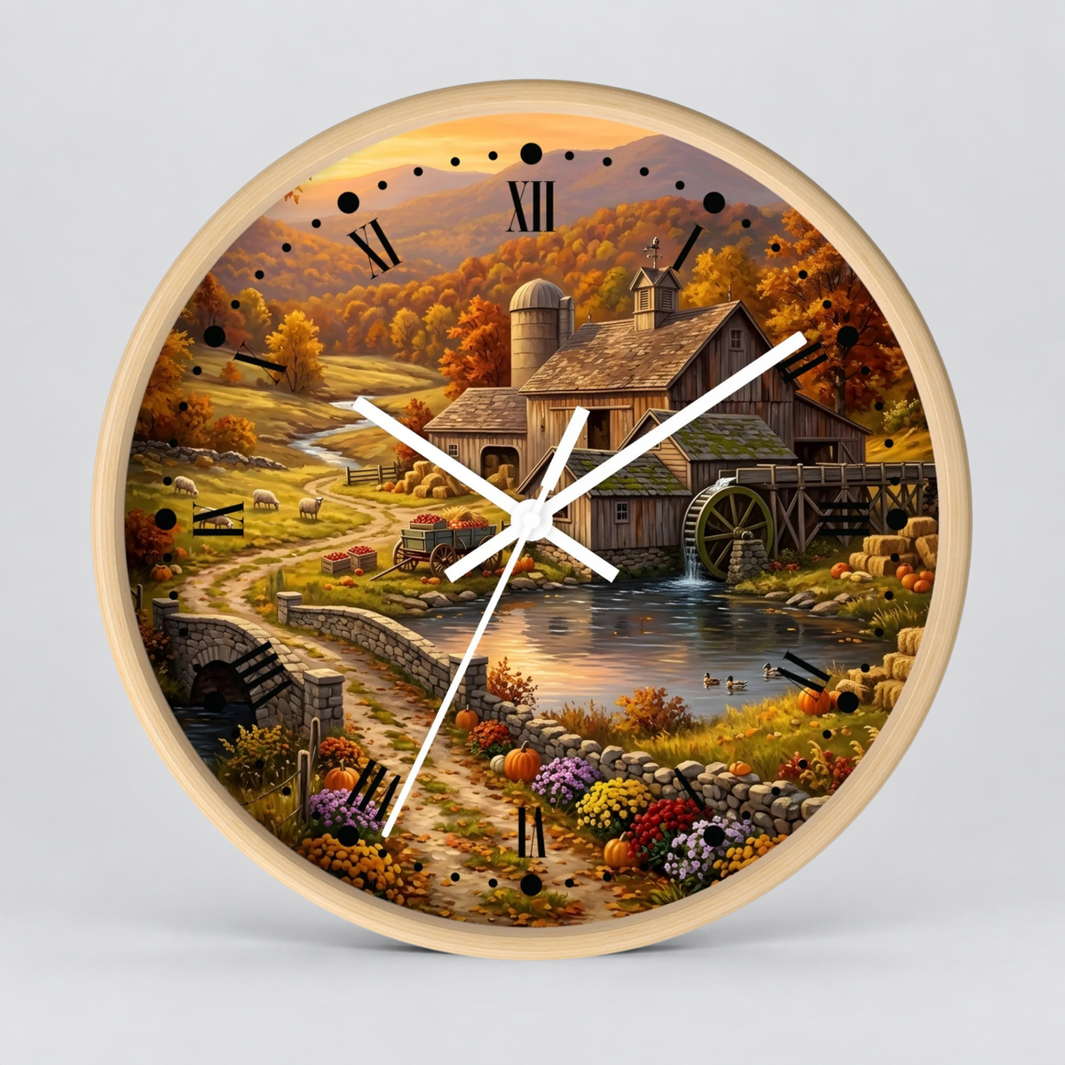 Round wall clock with a light wood frame and a detailed autumn farm landscape printed on the face, featuring a barn, water wheel, pond, flowers, and Roman numerals.