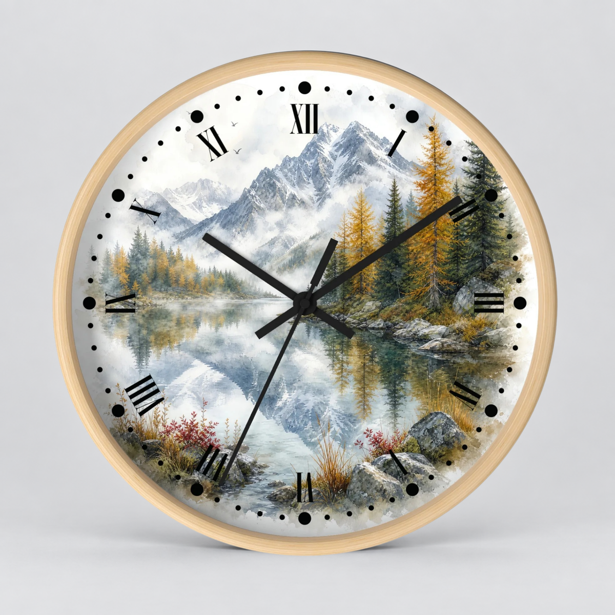Round wall clock with a light wood frame and a scenic landscape print featuring mountains, pine trees, a reflective lake, and black Roman numerals, shown against a light gray background.