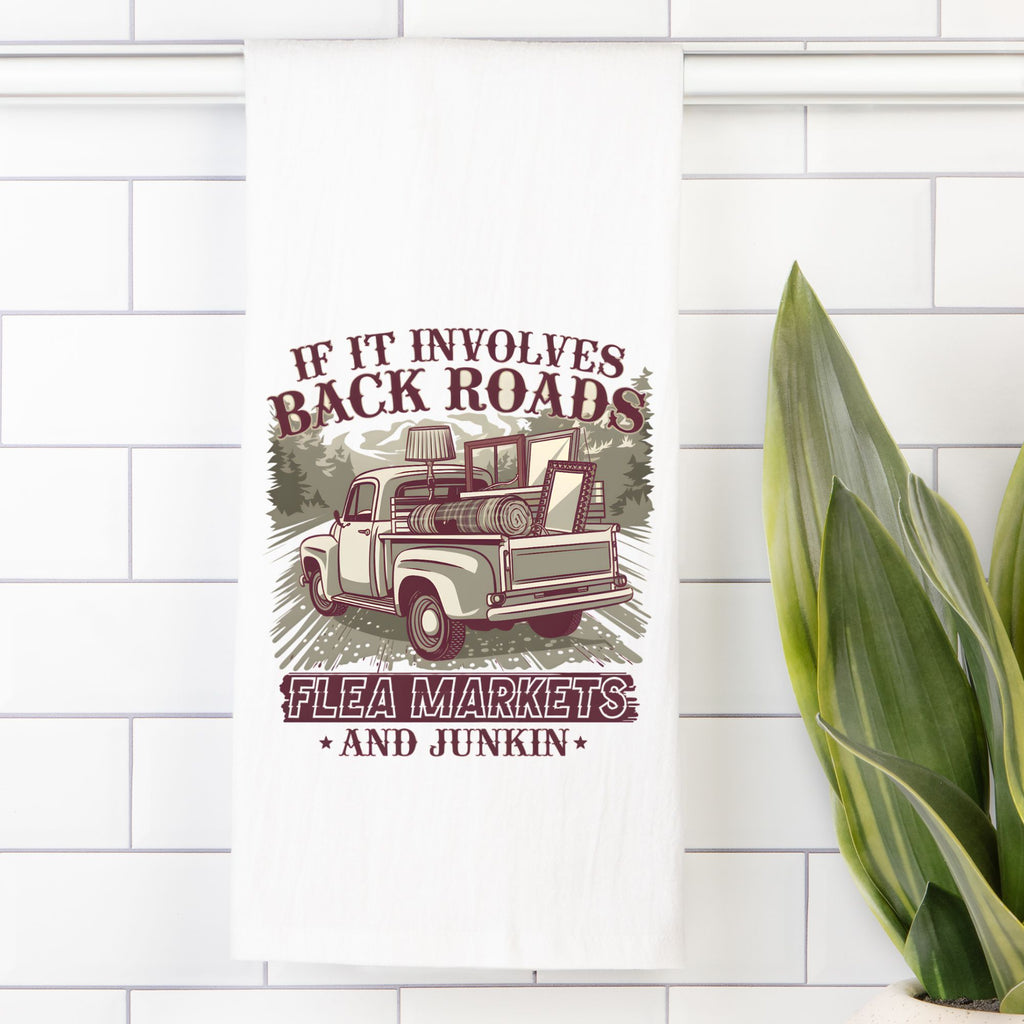 Decorative tea towel with a vintage truck graphic and text on a white tiled wall.