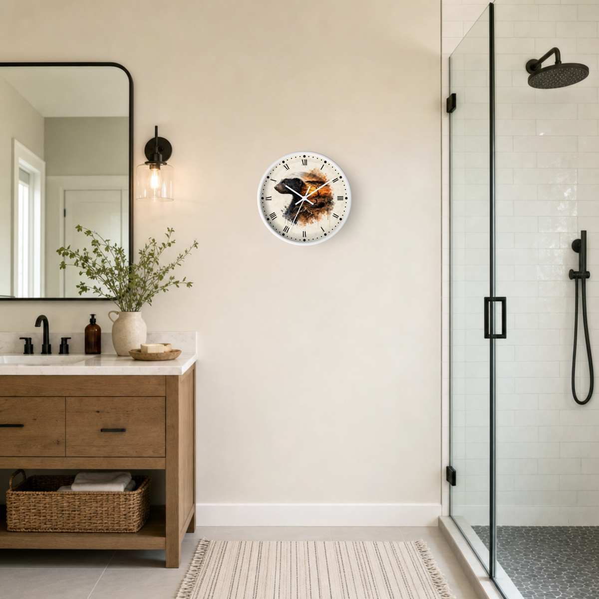 A round wall clock with a badger illustration and a fiery orange-brown background, mounted on a beige wall in a modern bathroom next to a wooden vanity and glass shower enclosure.