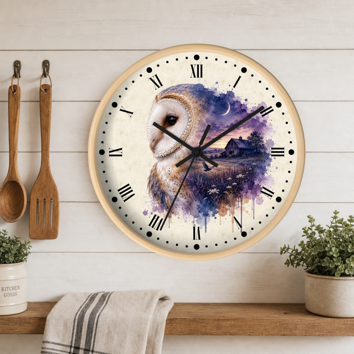 A round wall clock with a light wood frame hangs on a white wood-paneled wall above a shelf. The clock face features a watercolor-style barn owl illustration in purple, blue, and brown tones over a cream background, with black Roman numerals and hands.