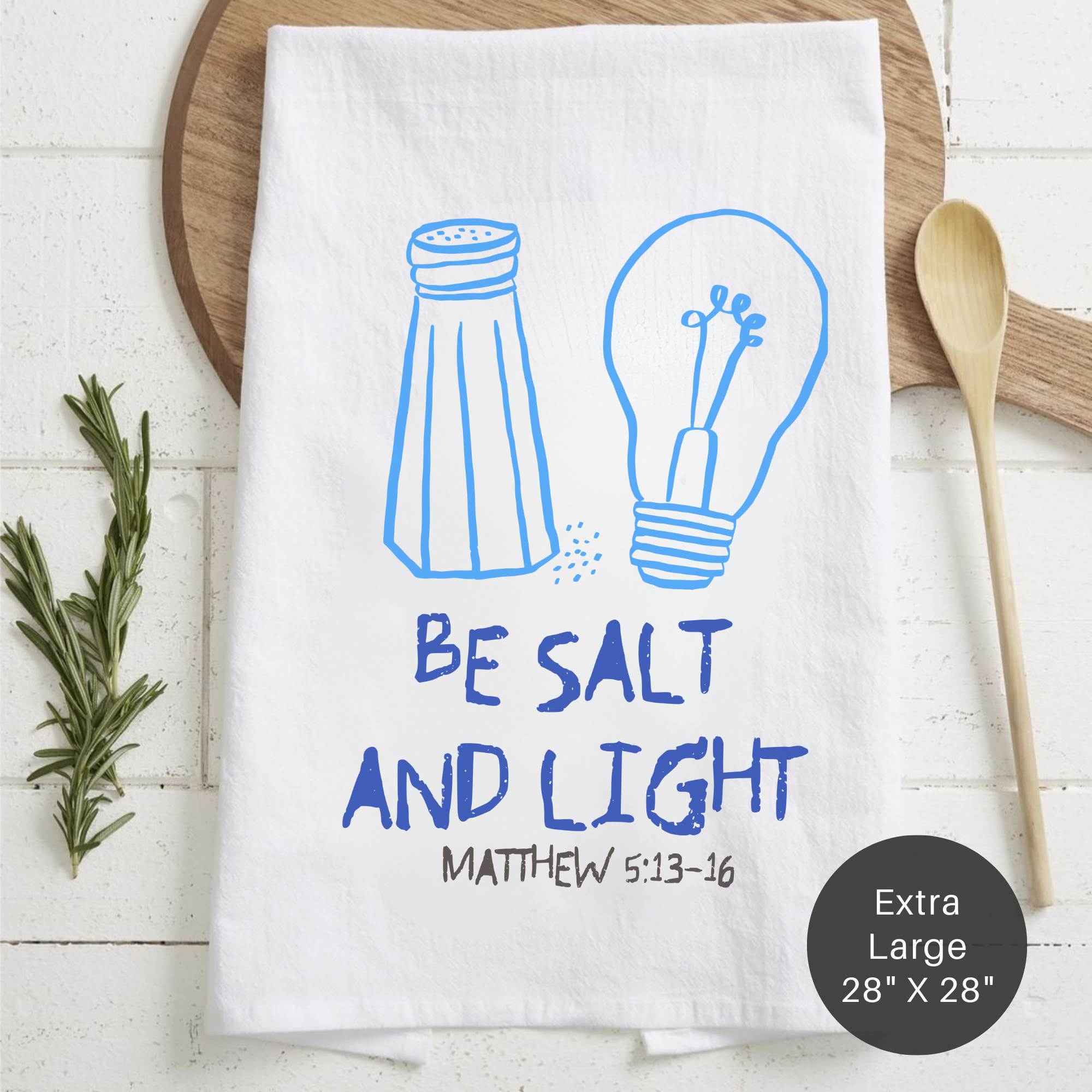 White towel with blue illustrations of a salt shaker and light bulb, featuring the text 'Be Salt and Light' and 'Matthew 5:13-16'.