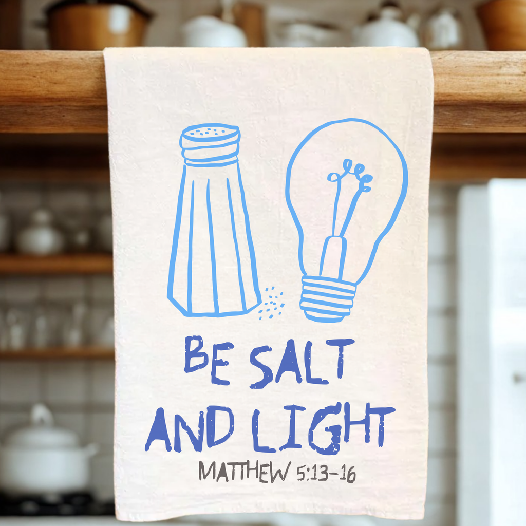 Kitchen towel with salt and light illustration and 'Be Salt and Light' text in a kitchen setting