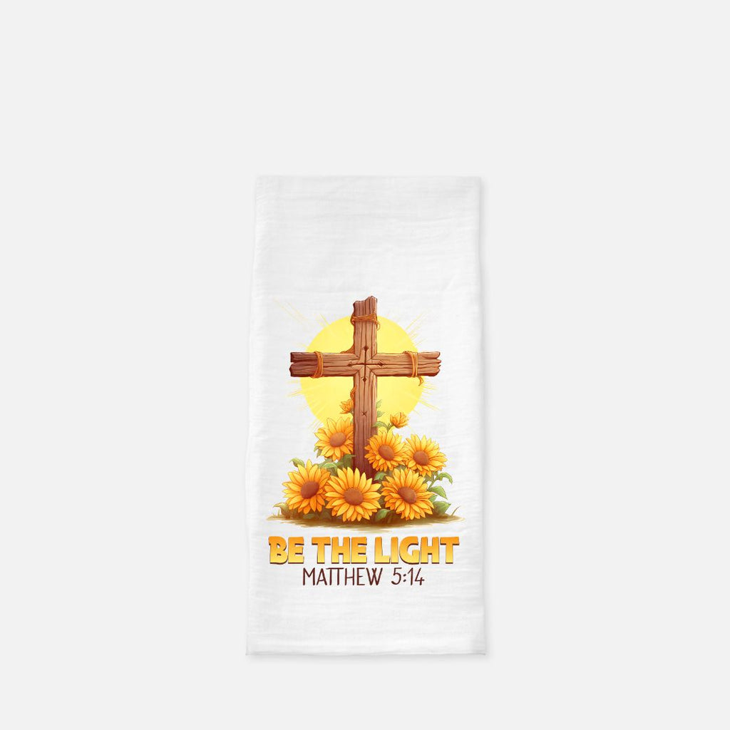 Decorative tea towel with cross and sunflowers design on a white background