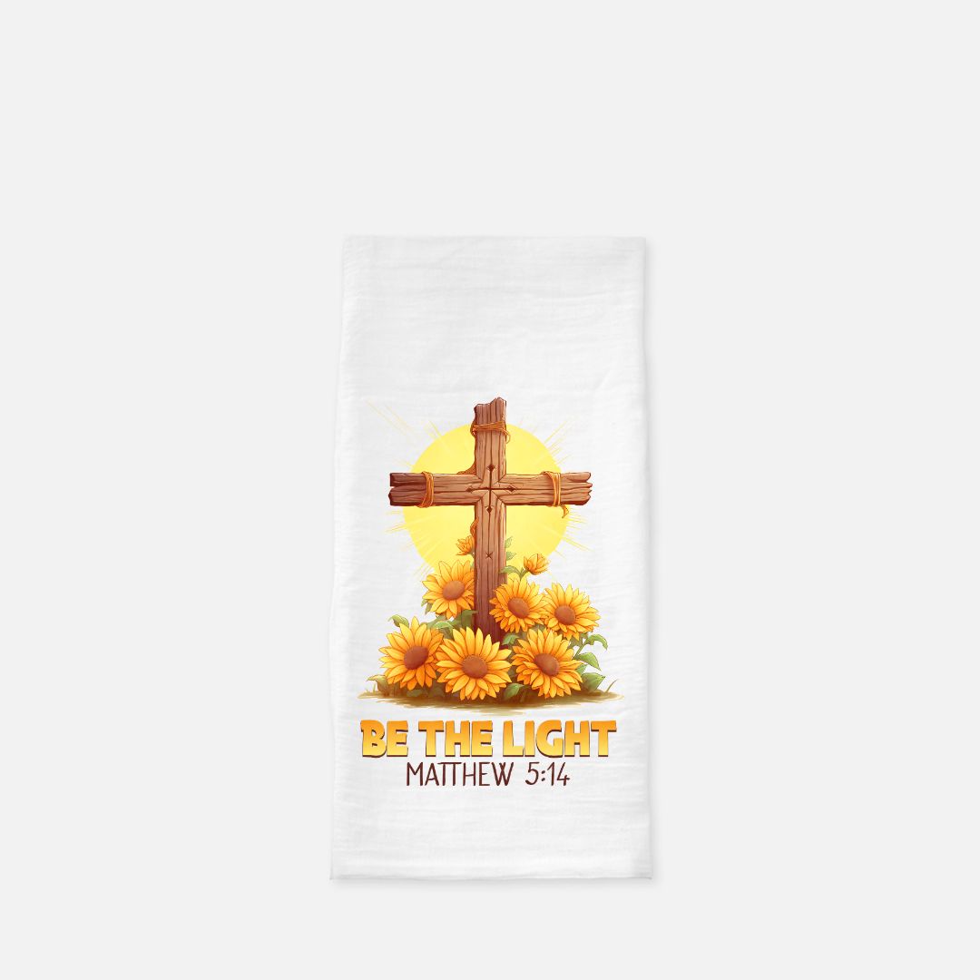 Decorative tea towel with cross and sunflowers design on a white background