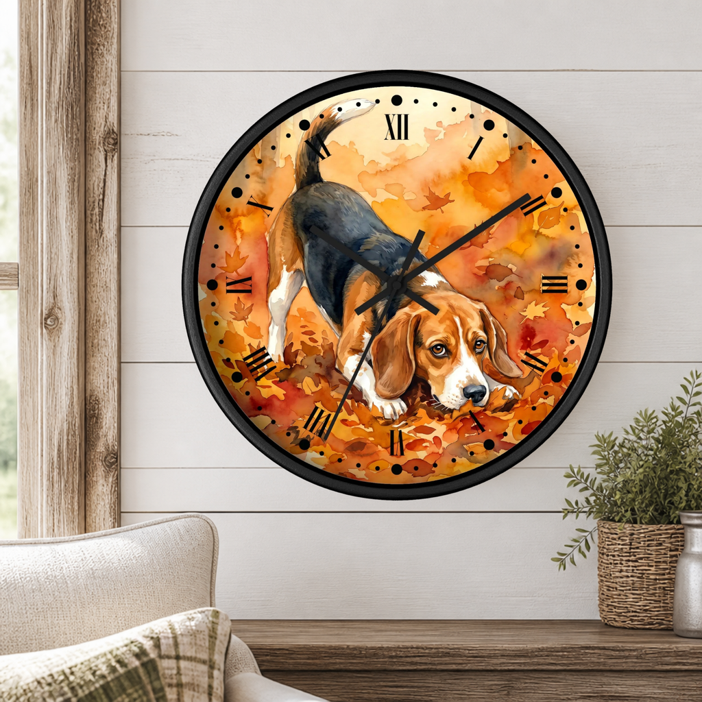 A round wall clock with a black frame and Roman numerals, featuring a painted beagle dog walking through orange autumn leaves. The clock is mounted on a white shiplap wall above a wooden table with a small potted plant and part of a sofa visible.