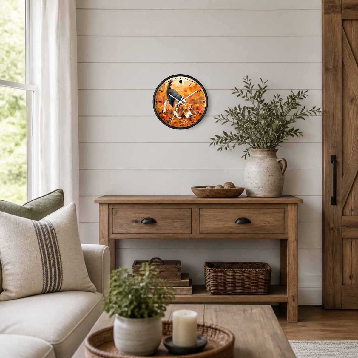 A round wall clock with a rustic autumn beagle dog design hangs on a white shiplap wall above a wooden console table in a styled living room setting.