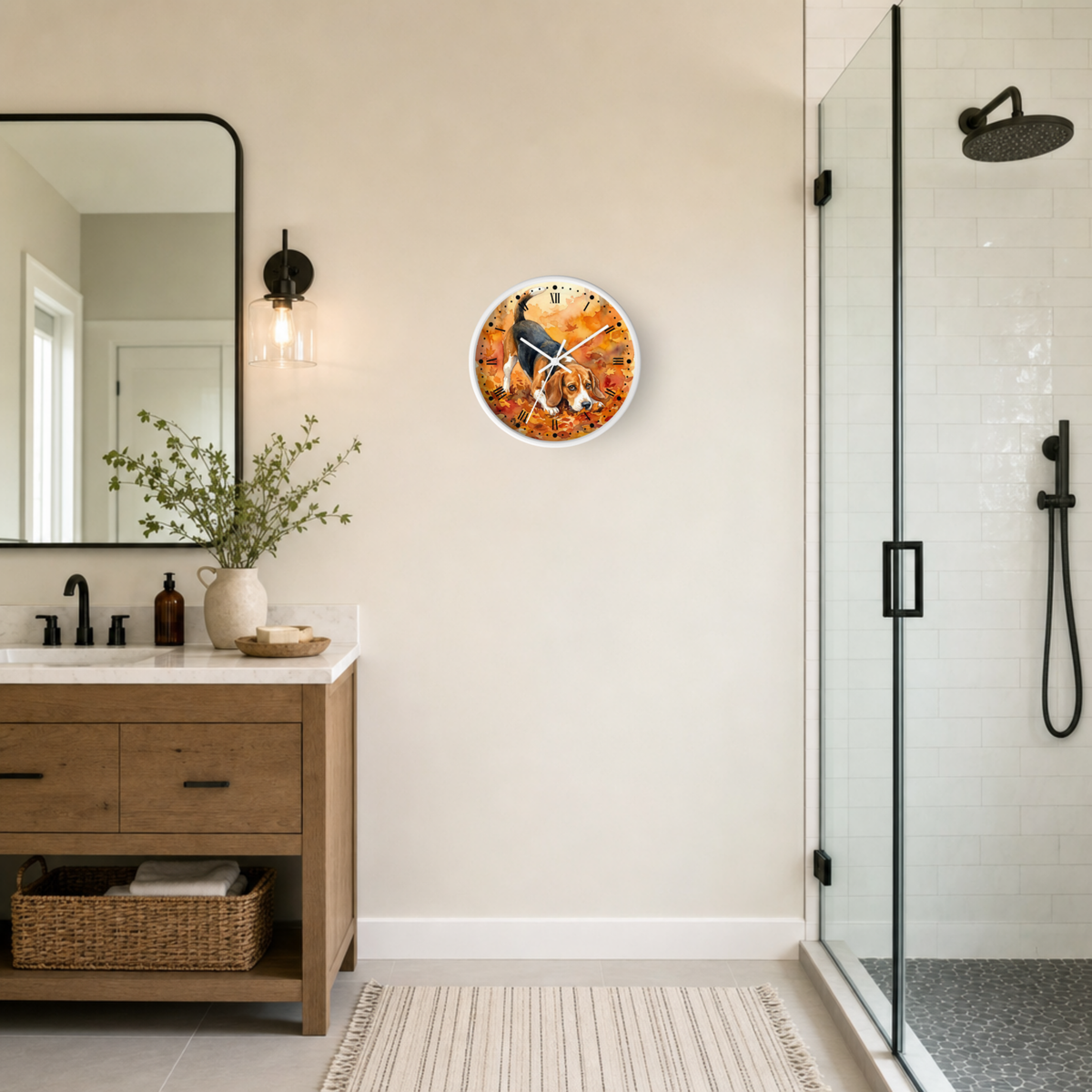 A round wall clock with a colorful autumn beagle dog illustration hangs on a beige wall in a modern bathroom next to a wooden vanity and glass shower enclosure.