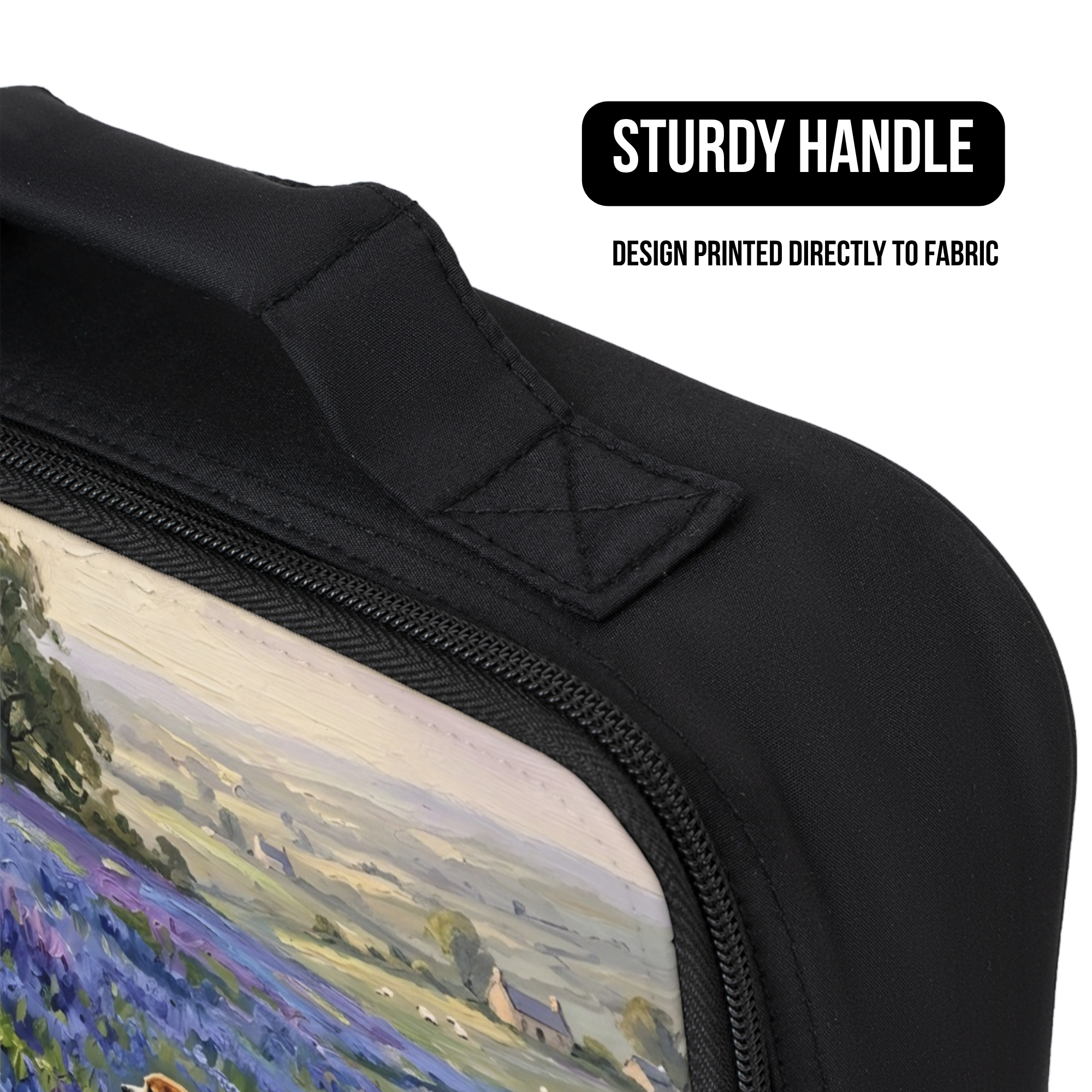 Close up of a black lunch bag with a scenic design printed directly to fabric on a white background