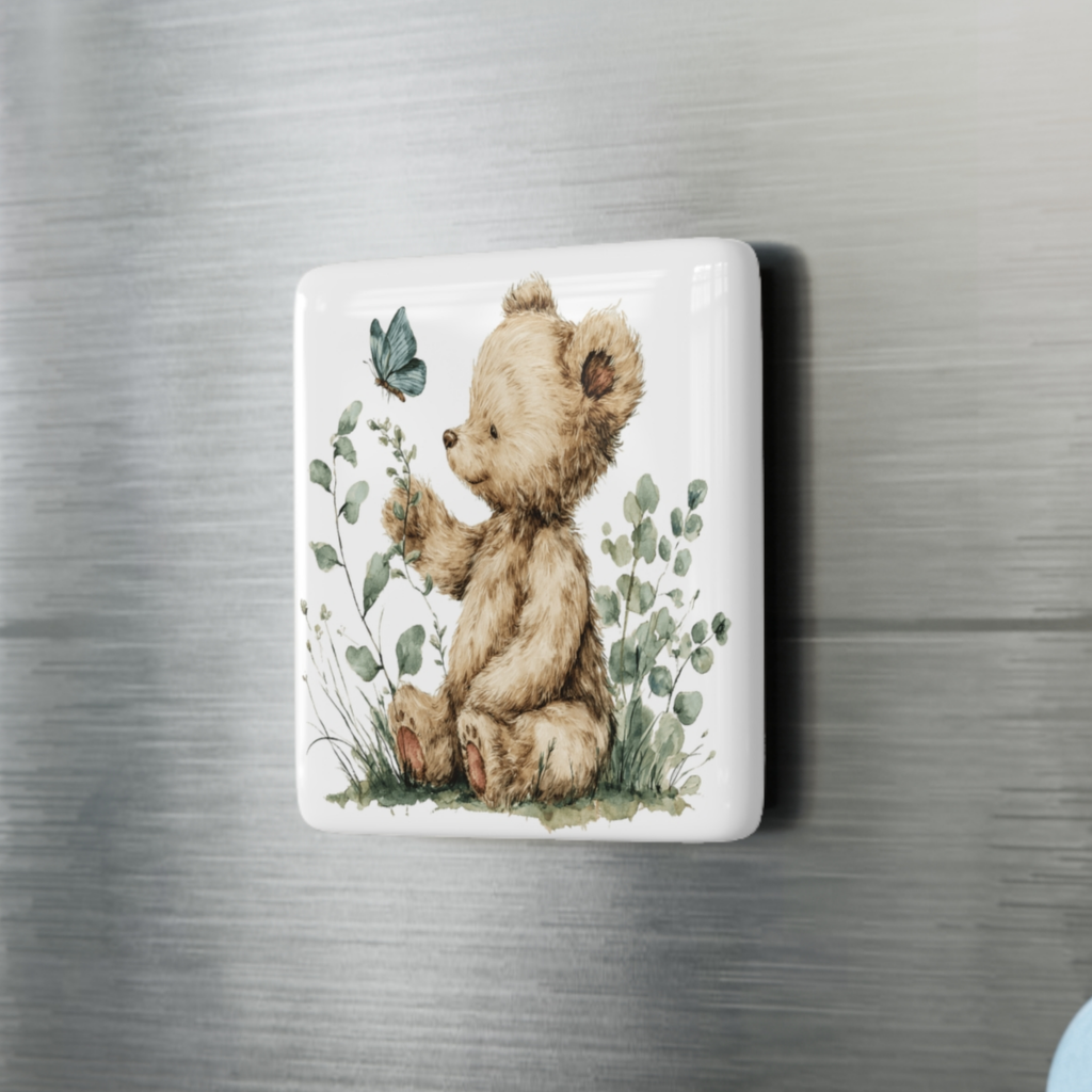 Decorative square magnet with a teddy bear and butterfly design on a metallic surface