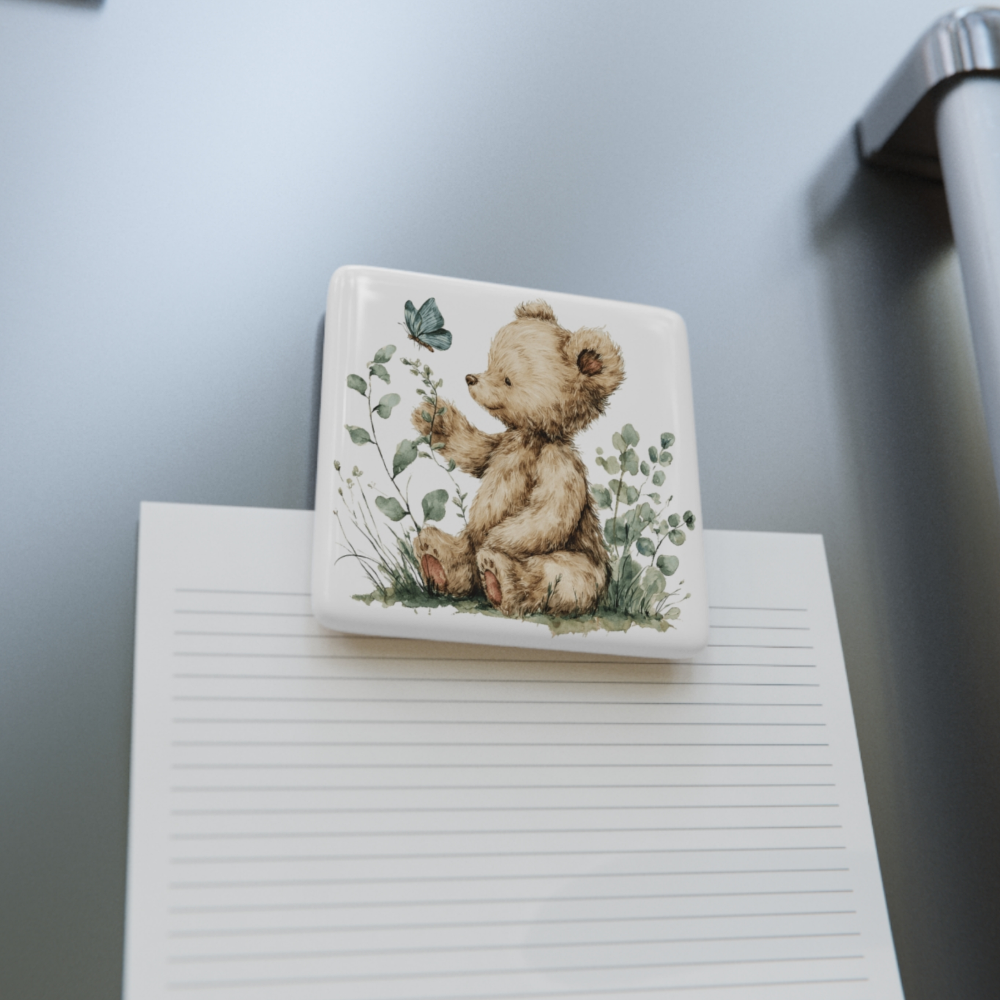 Square porcelain magnet with a teddy bear illustration on a fridge