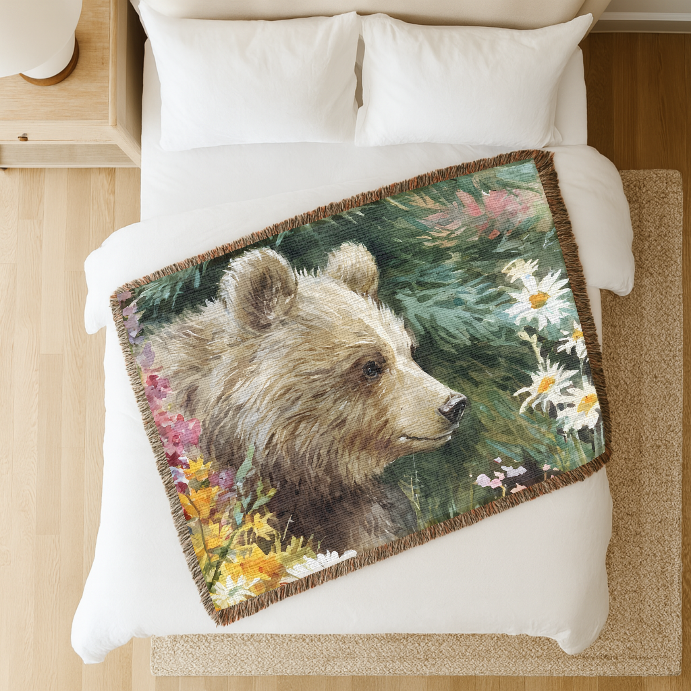 Horizontal woven blanket with a bear design on a bed