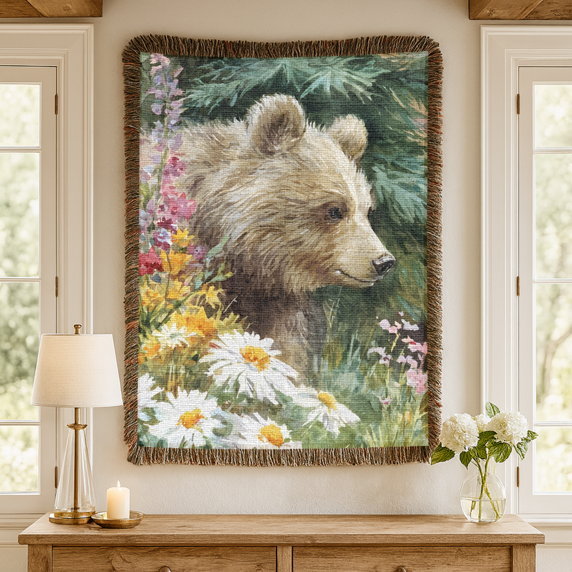 Vertical woven wall art tapestry of a bear surrounded by flowers on a wall above a wooden console table.