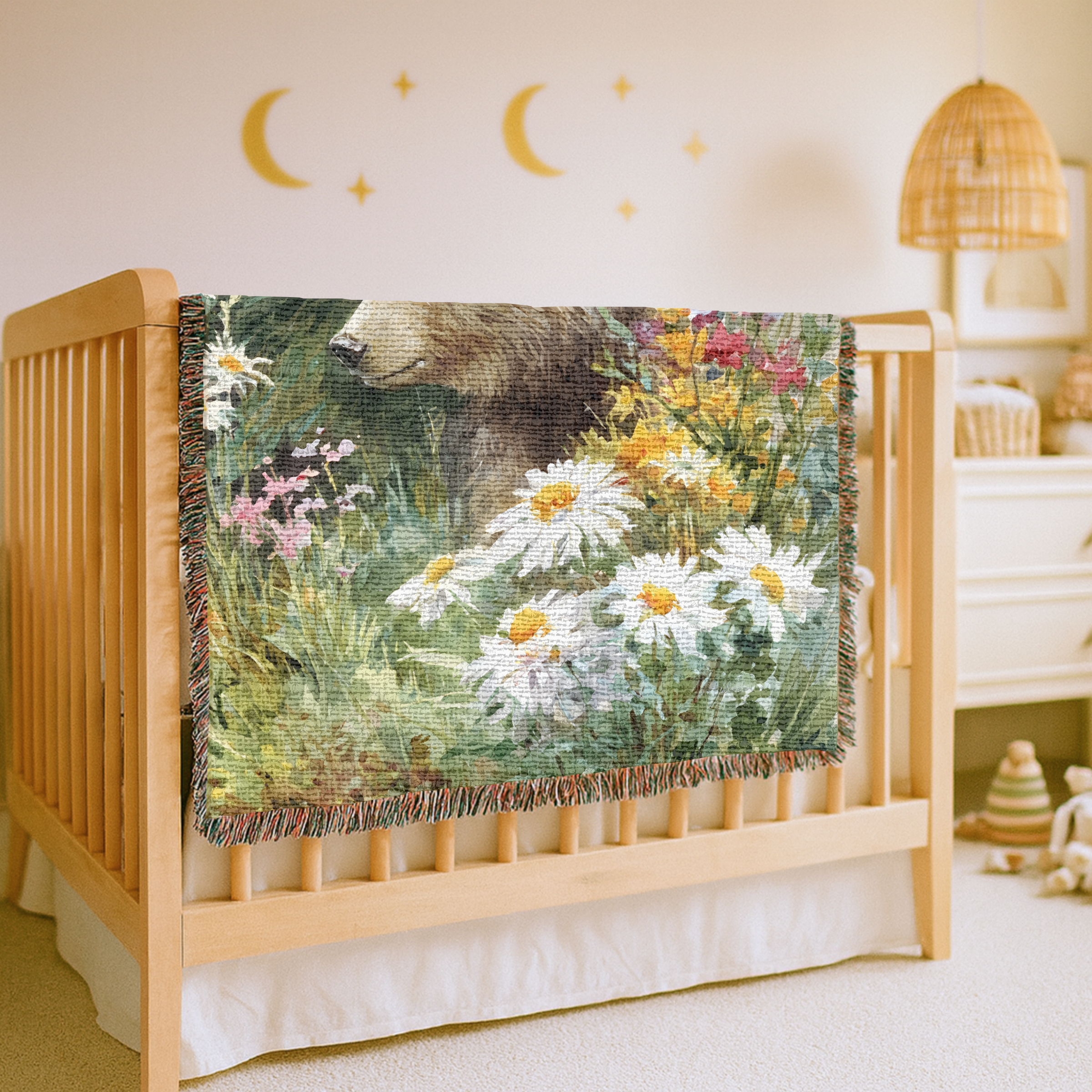 Crib with a decorative blanket featuring a bear and flowers in a nursery setting.