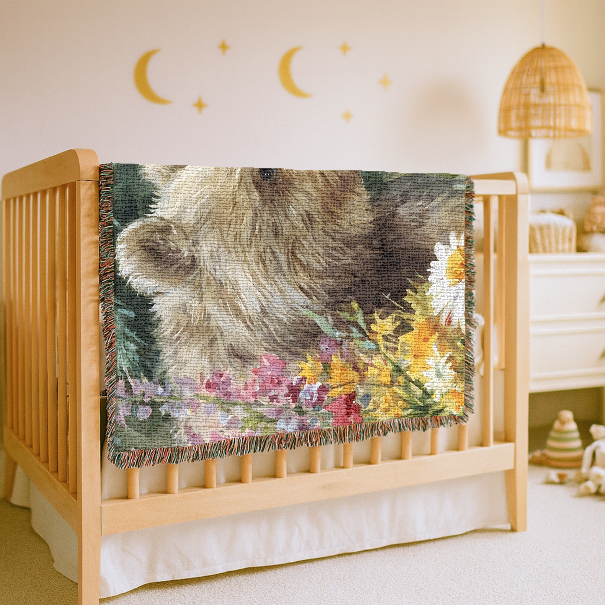 Crib with a decorative blanket featuring a bear and flowers in a nursery setting.