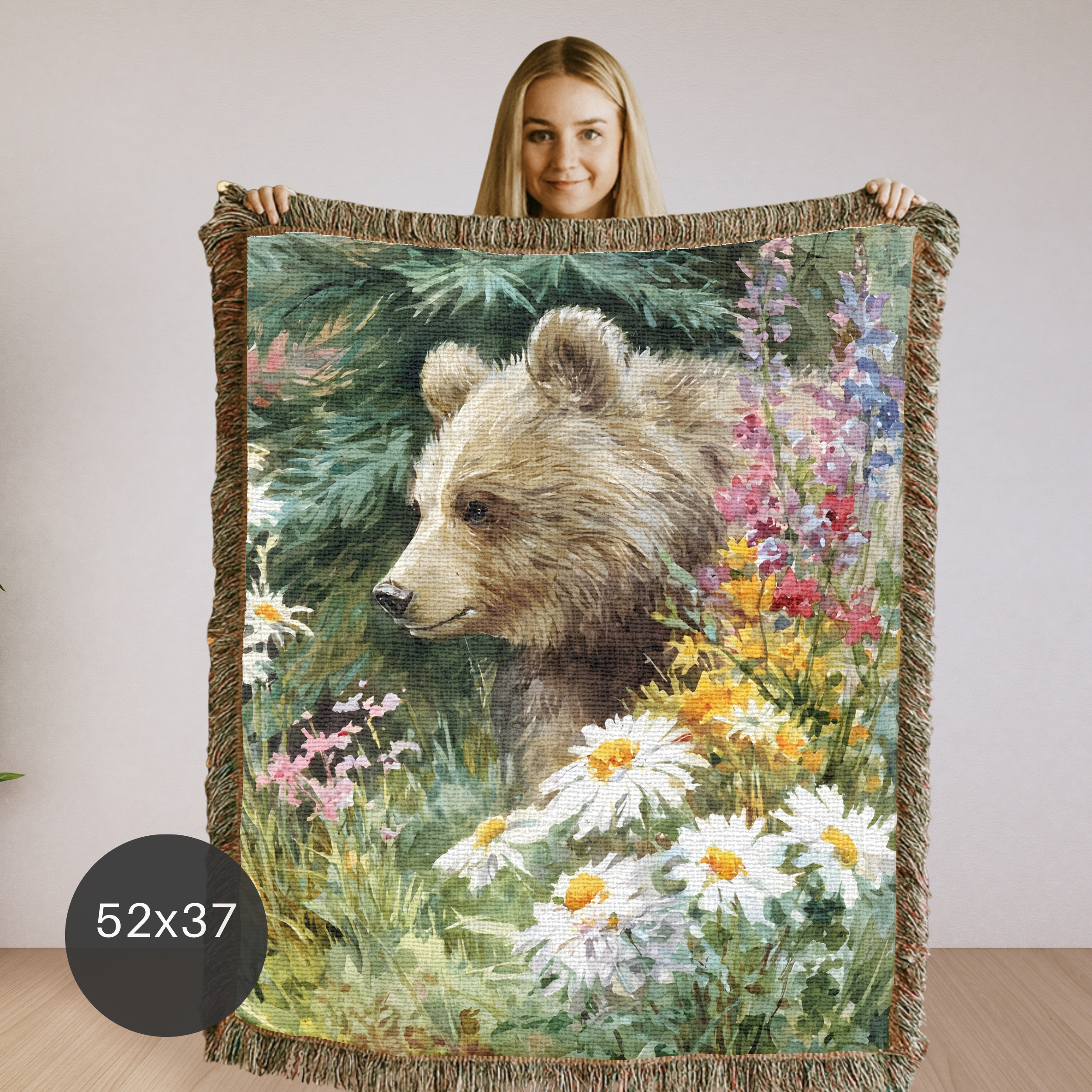 Woman holding a cotton woven blanket with a bear and floral design