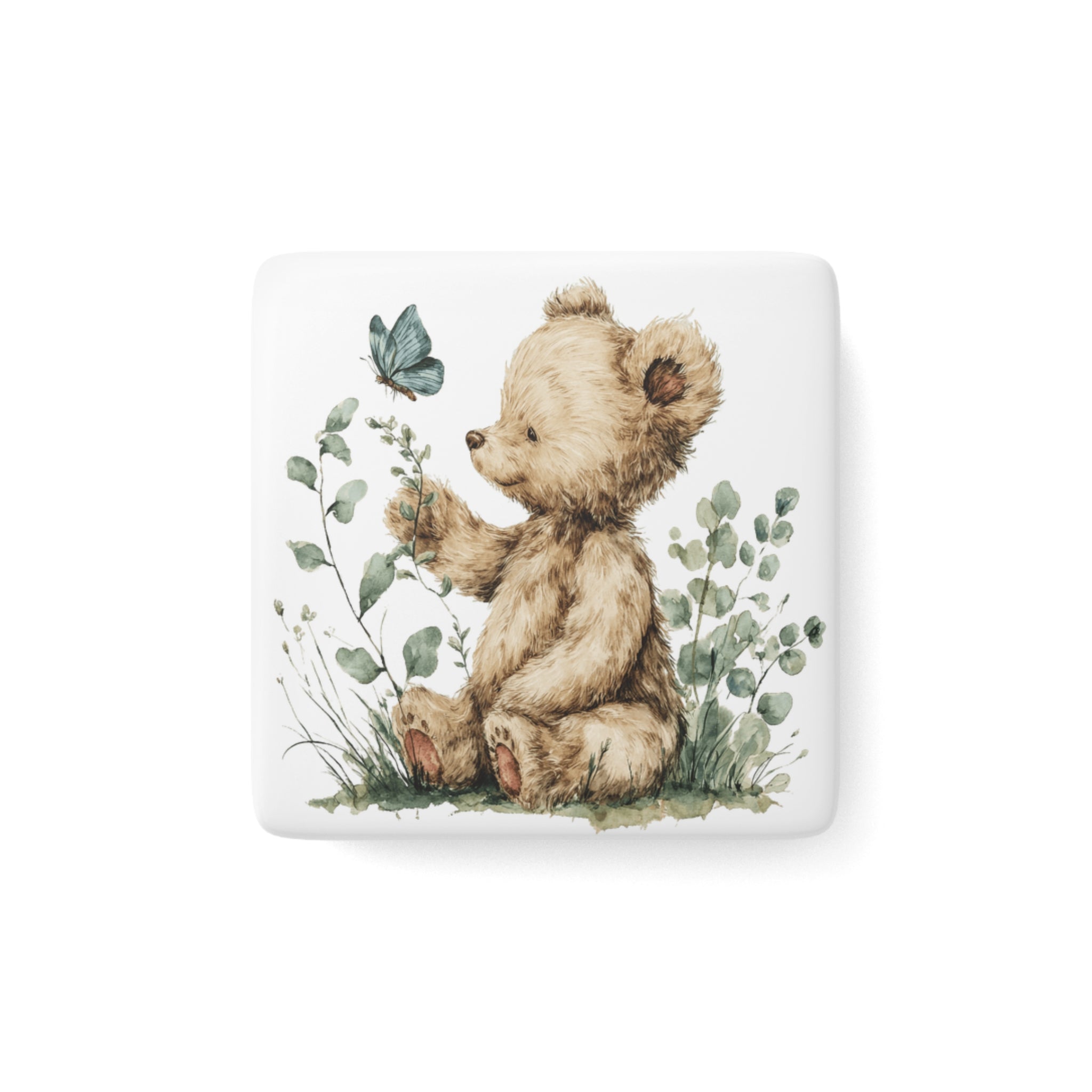Square porcelain magnet with a teddy bear, a butterfly, and greenery on a white background