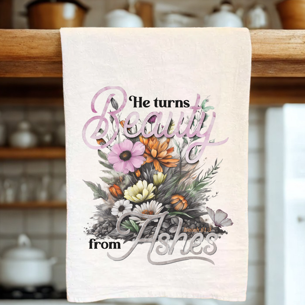 Floral towel with inspirational scripture quote on a wooden rack in a kitchen.