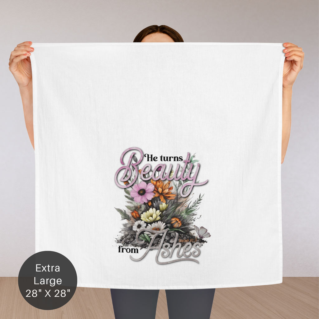 Person holding an extra large white tea towel with floral design and text.