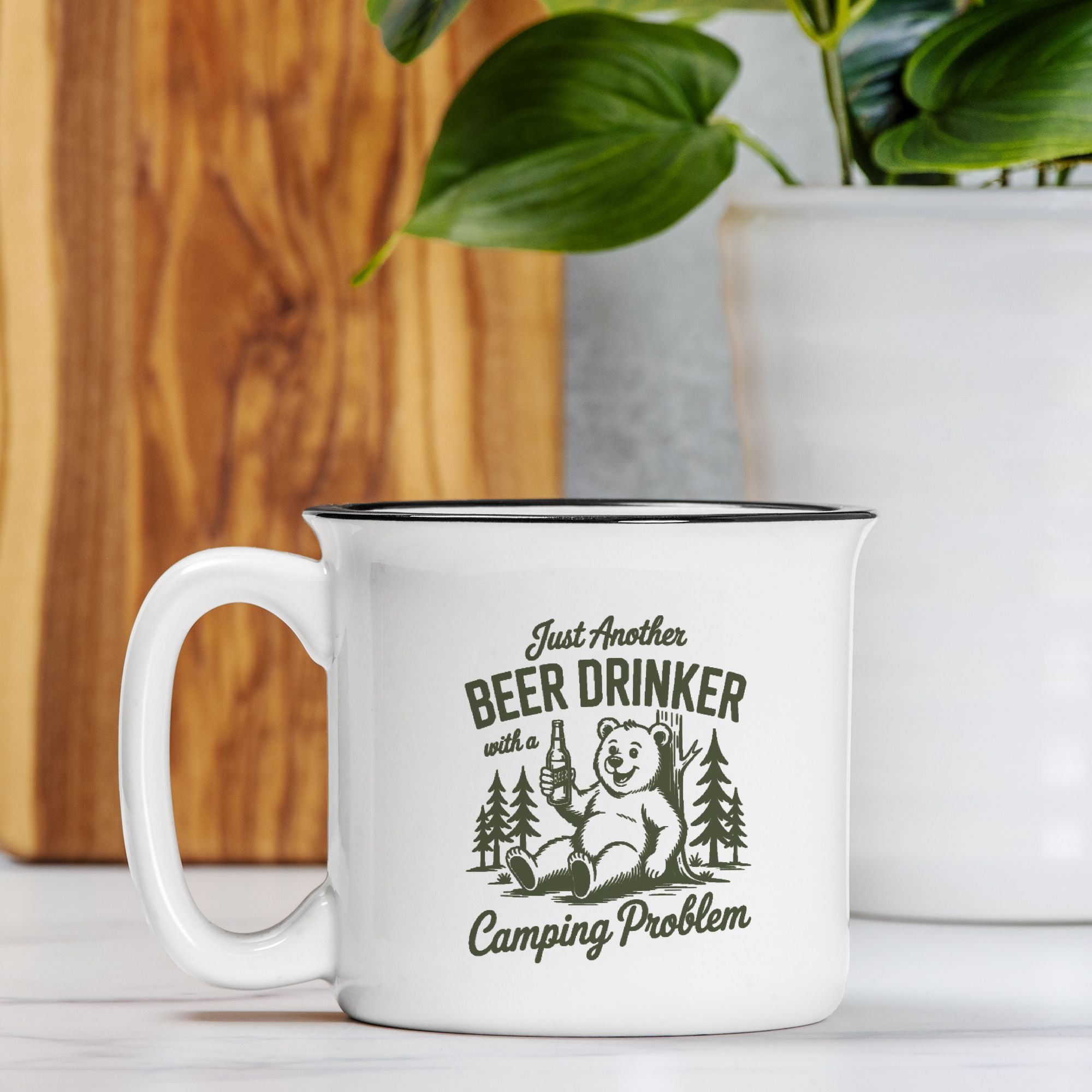 White mug with bear graphic and text on a wooden surface with a plant in the background