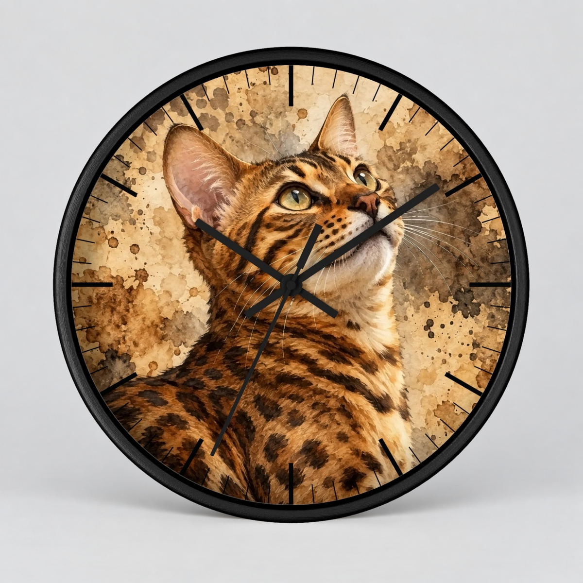 Round wall clock with a black frame and a printed design of a spotted cat on a textured beige background, shown against a light gray studio backdrop.