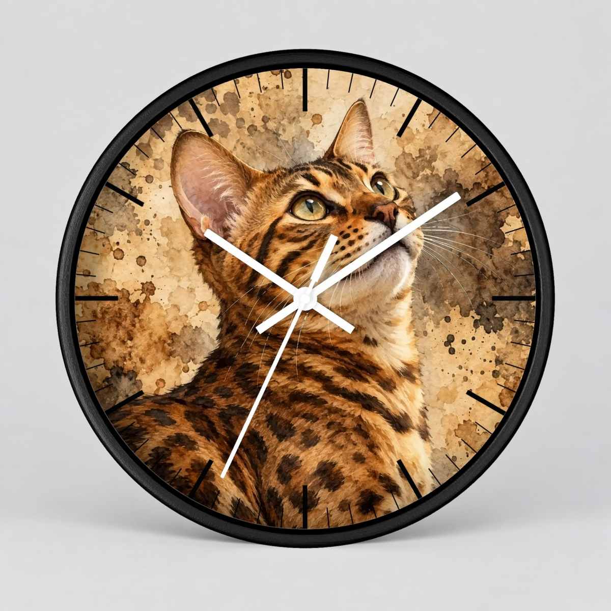 Round wall clock with a black frame and a printed cat face and fur pattern on the face, with white clock hands, shown against a light gray background.