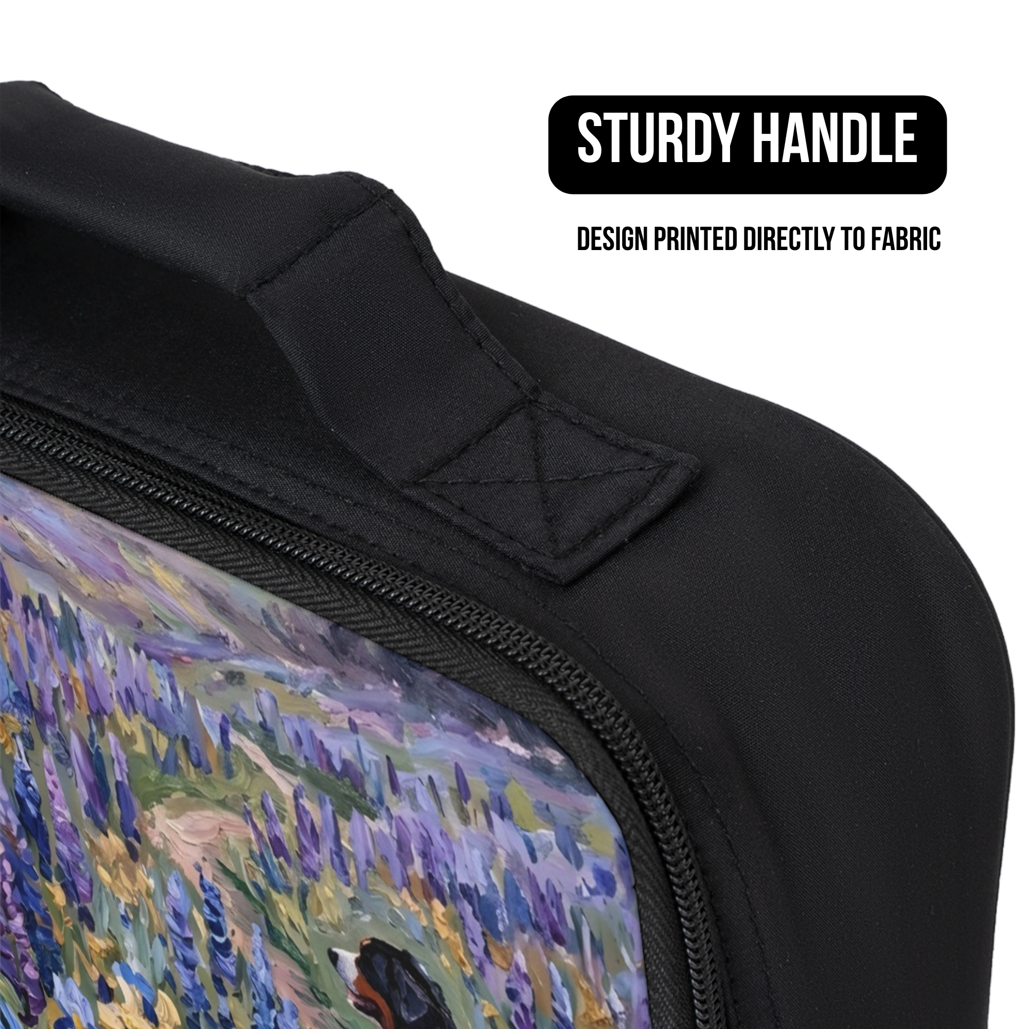 Black bag with a printed design of a field and dog, featuring a sturdy handle.