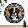 Wall clock with a dog's face design on a white wall with a plant and small pot.
